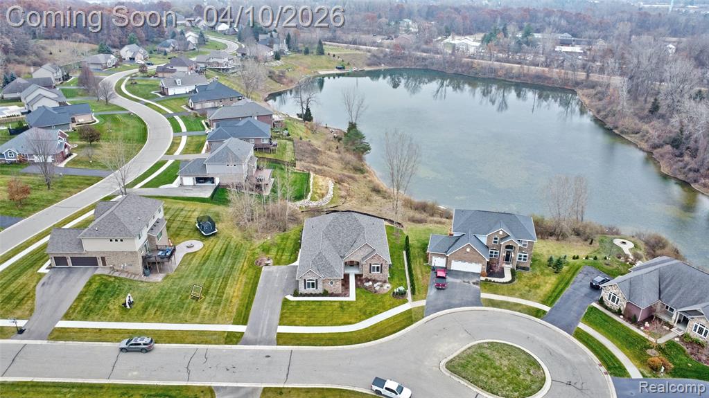 Aerial view of residential area featuring a large body of water