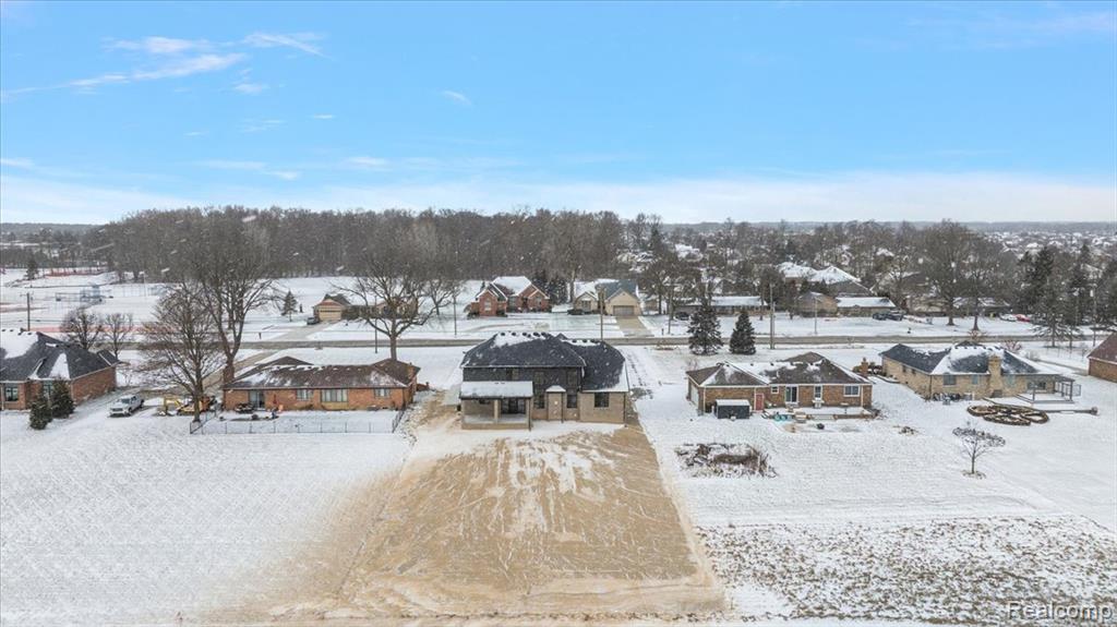 Snowy aerial view featuring a residential view