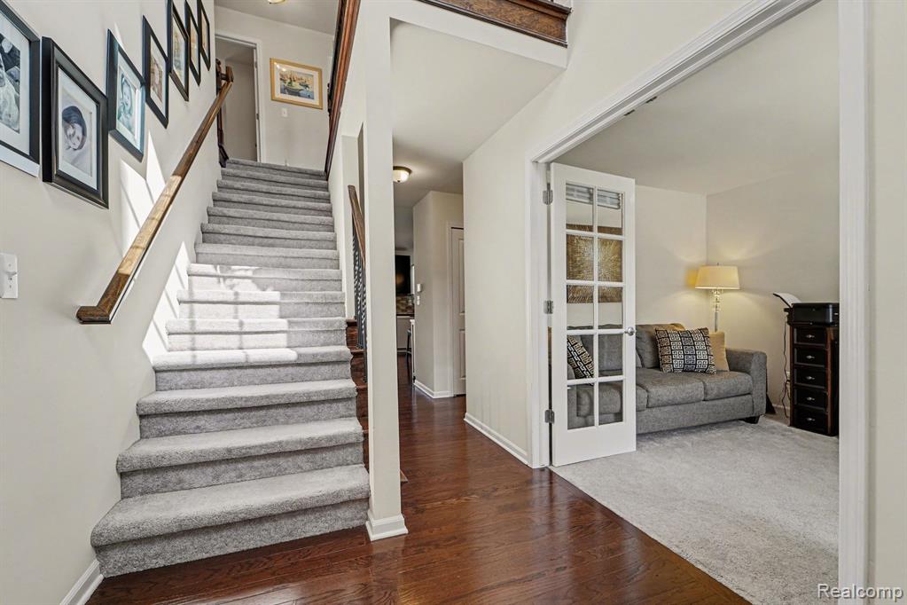 Stairway featuring wood finished floors and baseboards