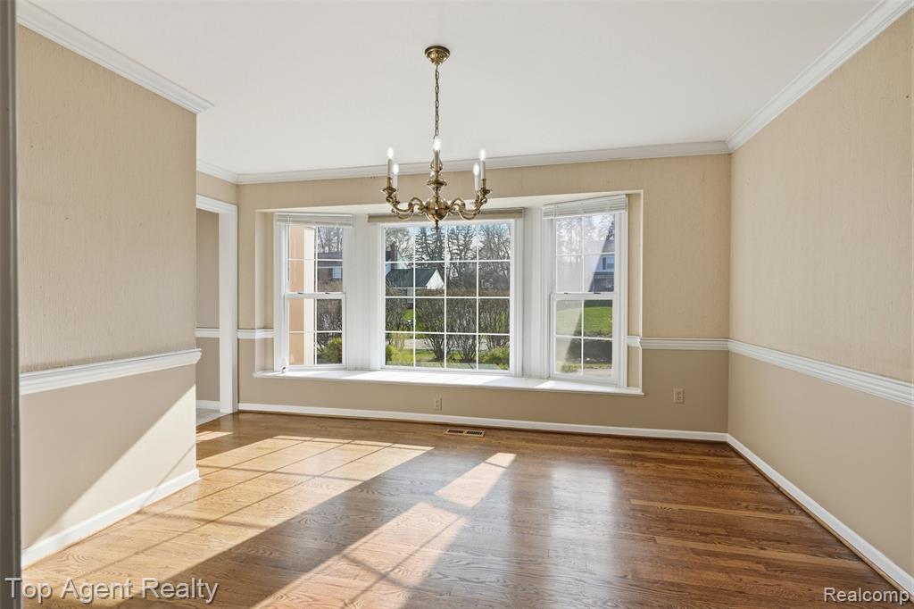 Unfurnished living room featuring crown molding, light wood-type flooring, and recessed lighting
