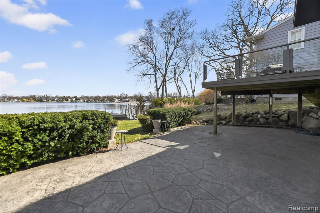 View of patio with a water view