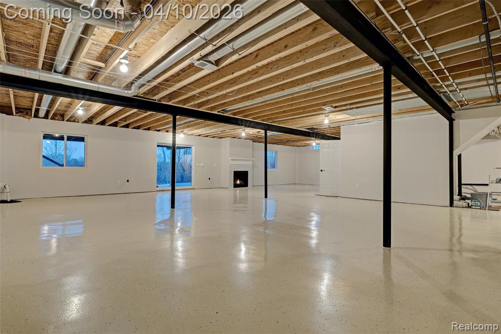 Below grade area featuring a lit fireplace