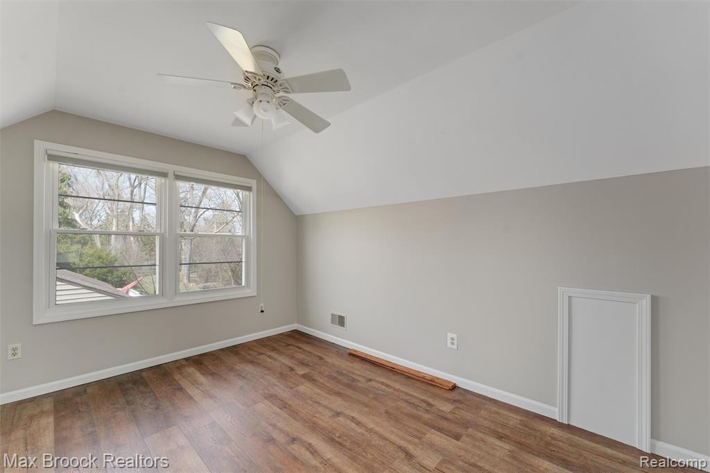 Bonus room featuring ceiling fan and wood finished floors