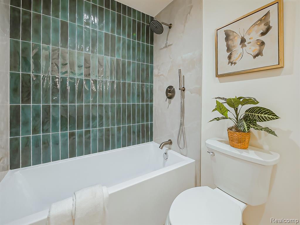Bathroom featuring shower / washtub combination and toilet