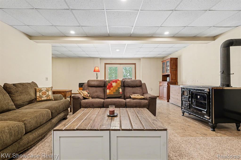 Living room with a drop ceiling and a wood stove