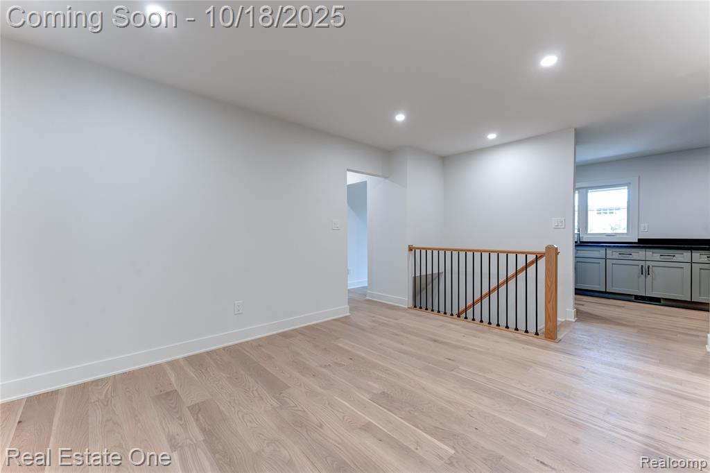 Unfurnished room with light wood-type flooring and recessed lighting