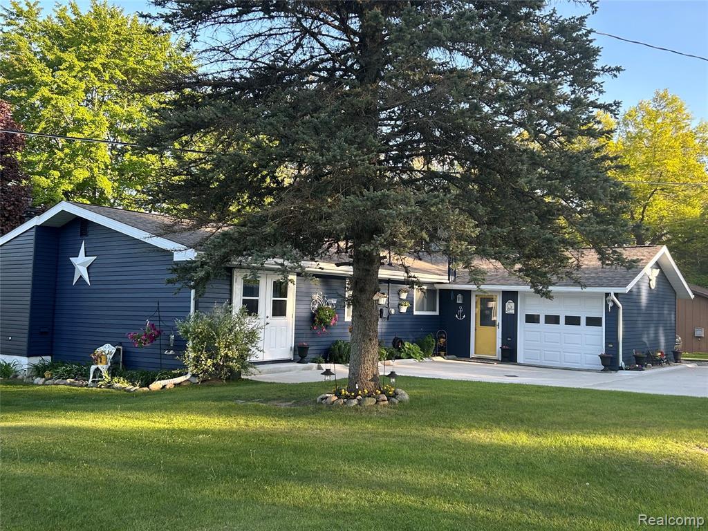 Ranch-style residence featuring deep blue siding and white trim