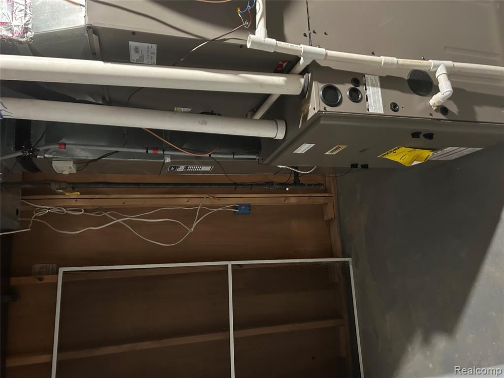 Utility room featuring heating unit