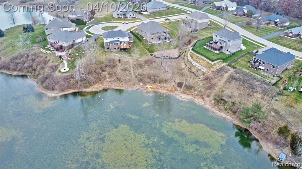 View of property location featuring a nearby body of water and nearby suburban area