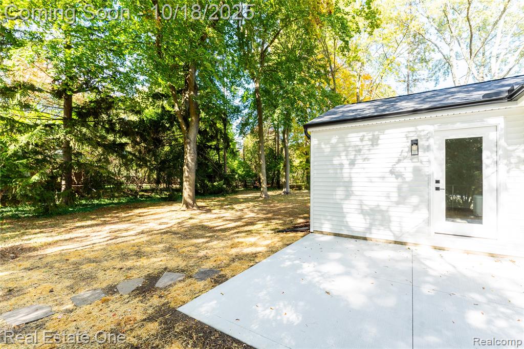 View of outbuilding featuring view of scattered trees