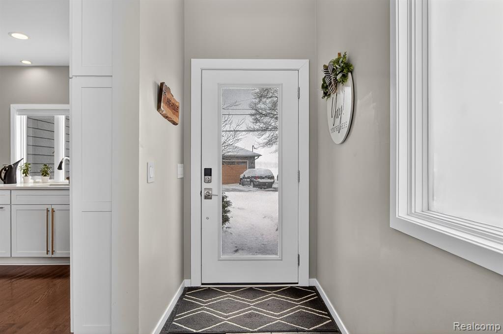Doorway with recessed lighting and wood finished floors