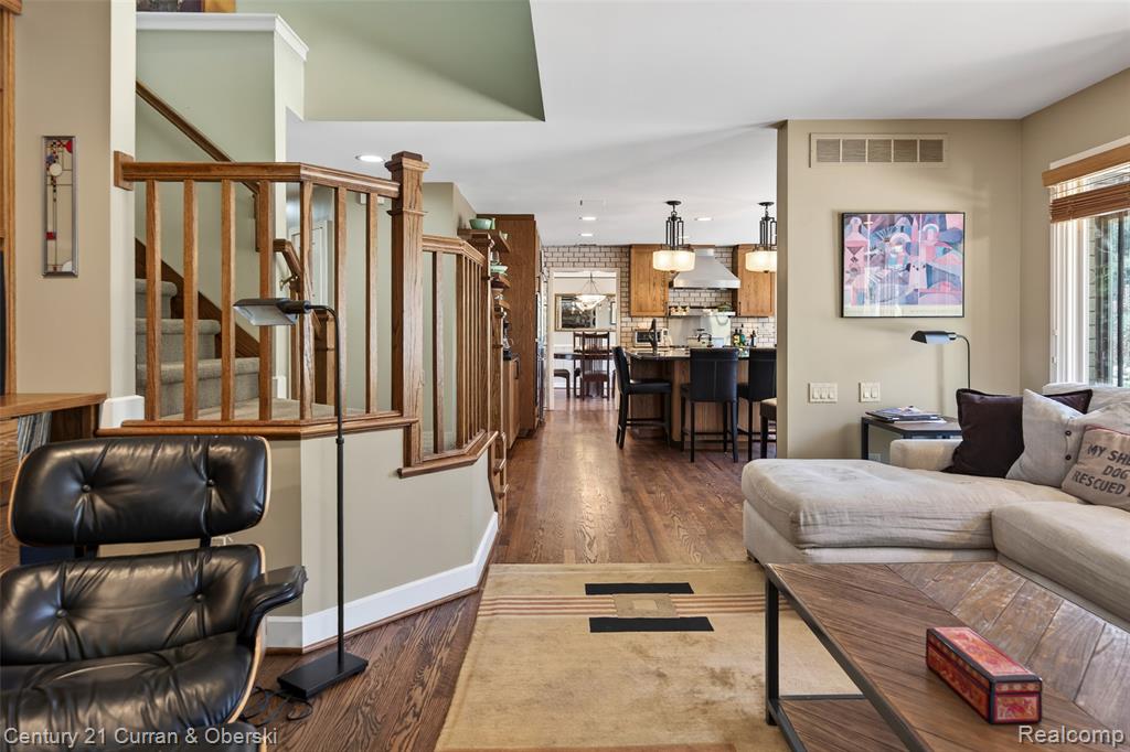Living area with dark wood finished floors and recessed lighting