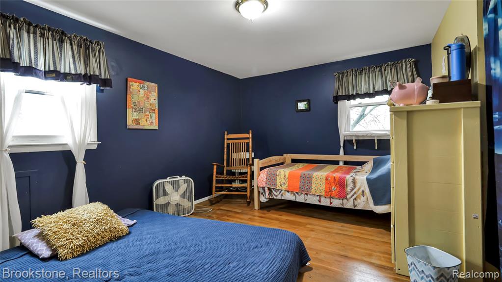 Bedroom featuring wood finished floors and baseboards