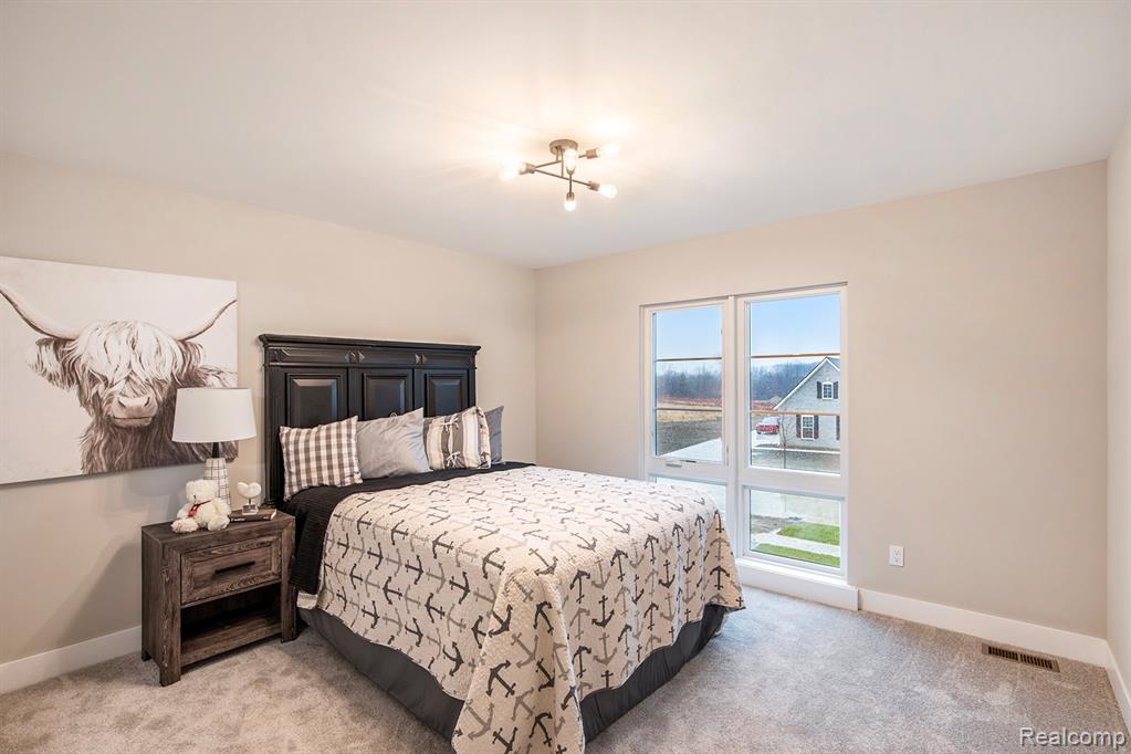 Bedroom with light colored carpet