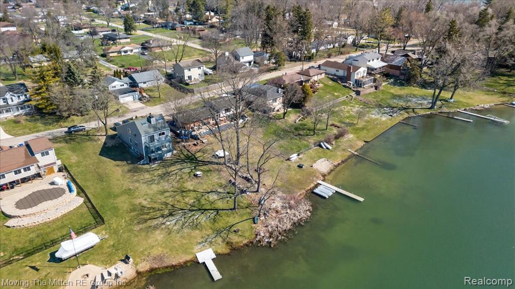 Aerial perspective of suburban area with a nearby body of water