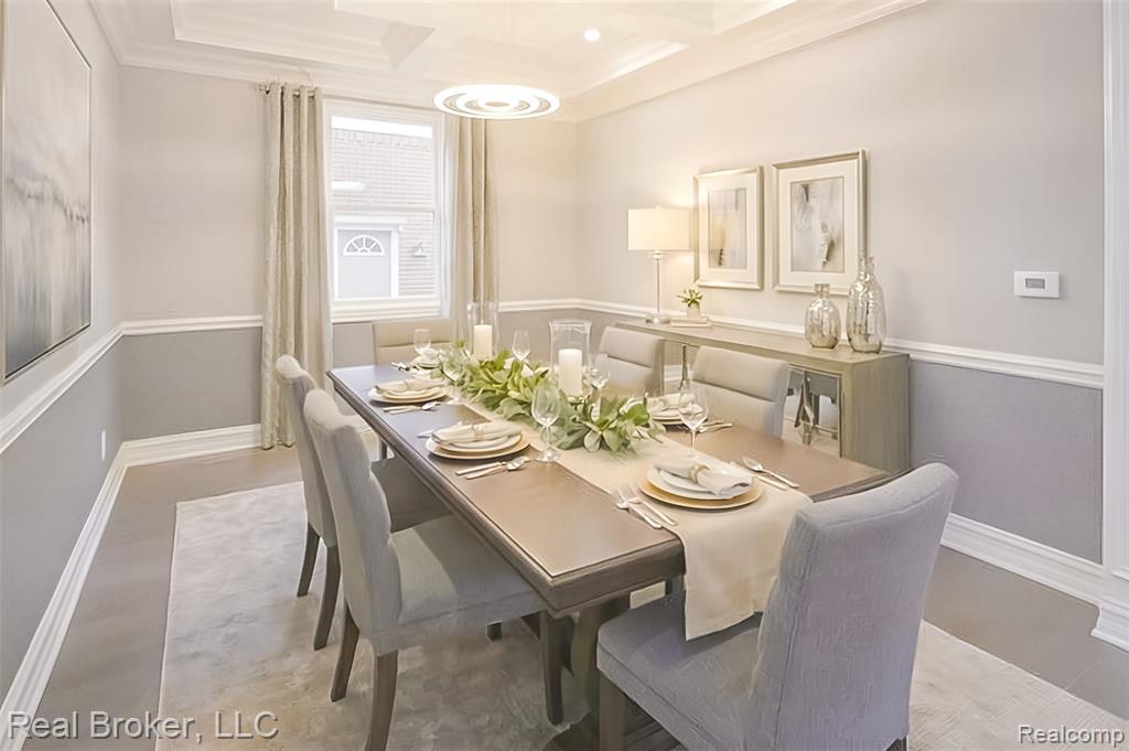 Dining room with coffered ceiling and ornamental molding
