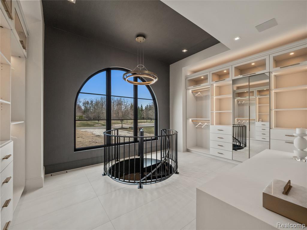 Spacious closet featuring light tile patterned flooring