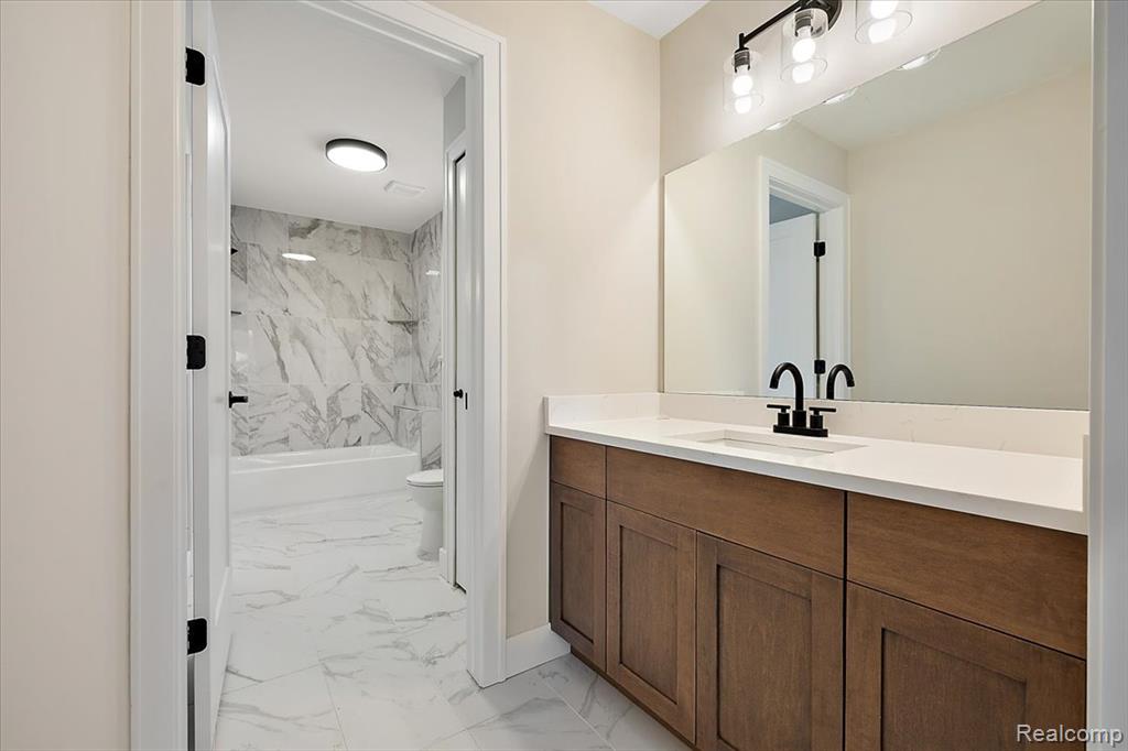 Bathroom with bathtub / shower combination, and vanity