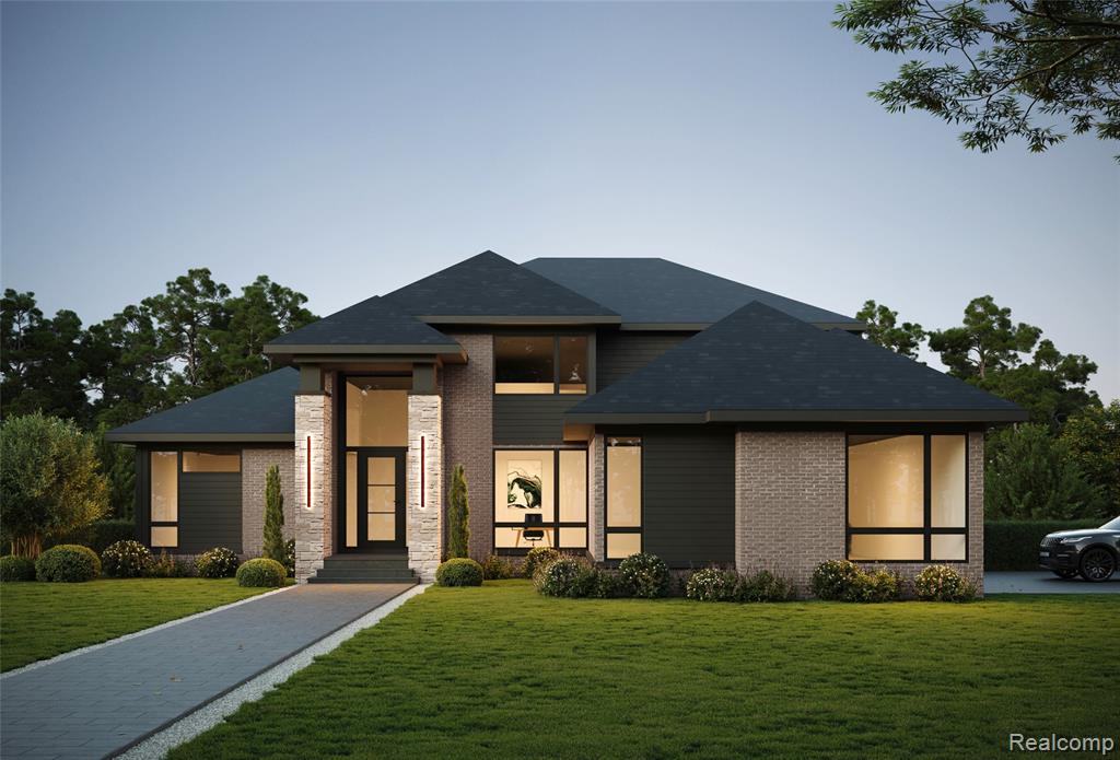 View of front facade with a front yard and brick siding