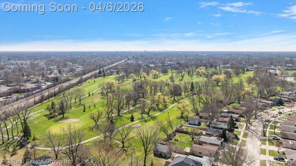 Aerial perspective of suburban area featuring a golf course