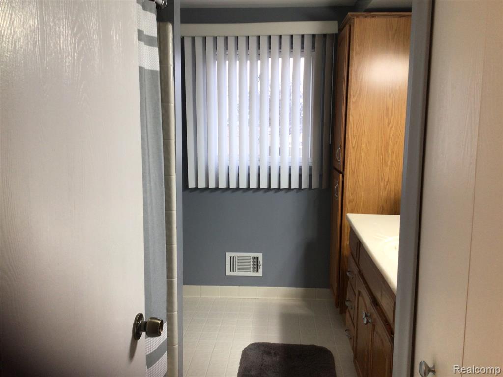 Full bathroom with vanity and a shower with curtain