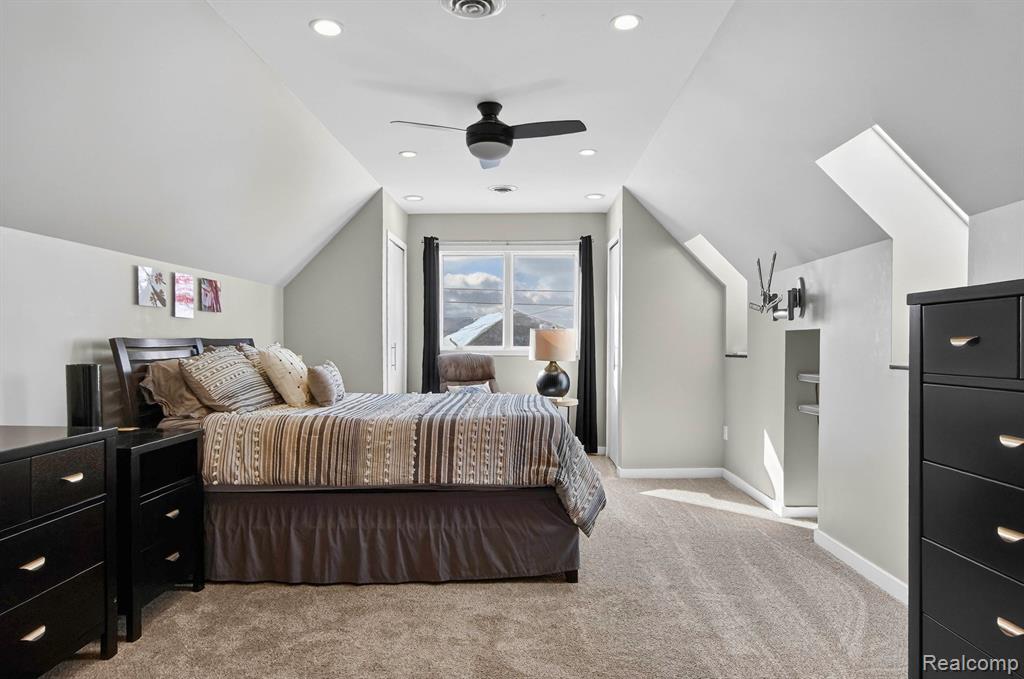 Bedroom with light colored carpet, lofted ceiling, a ceiling fan, and recessed lighting