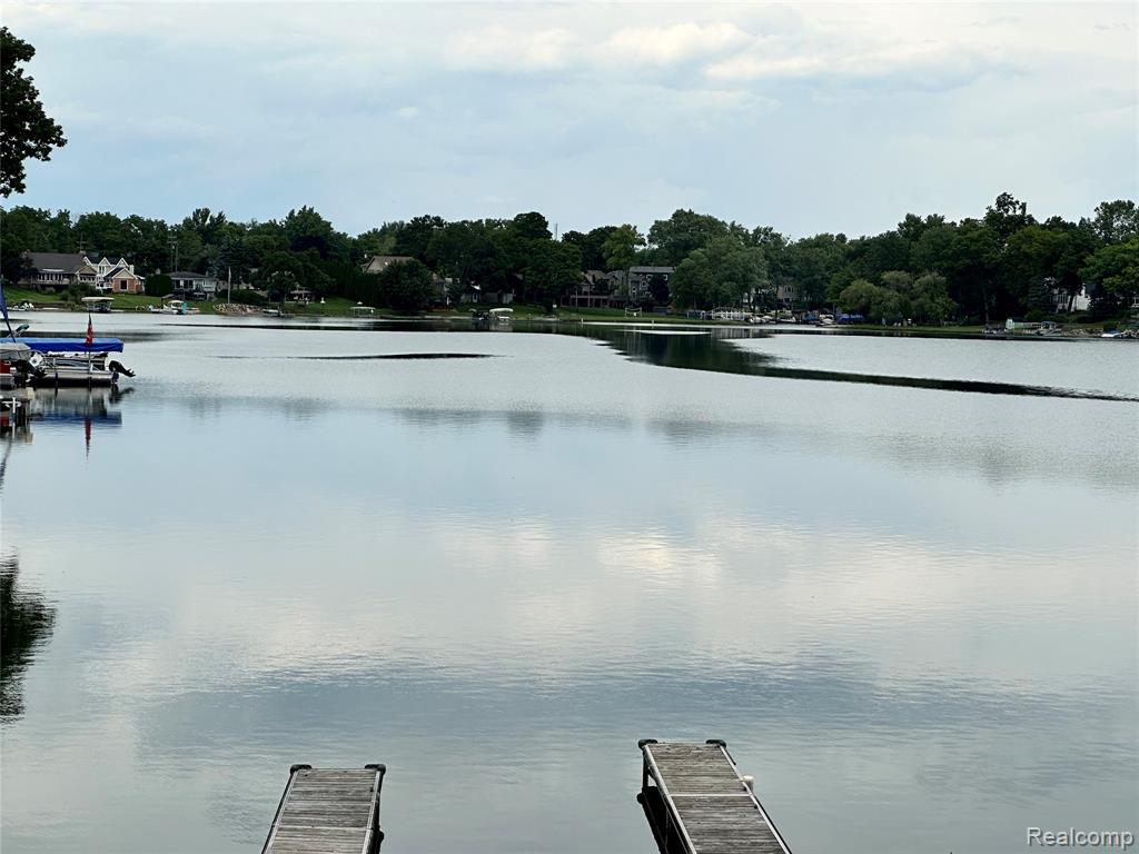 Dock area featuring a water view and a yard