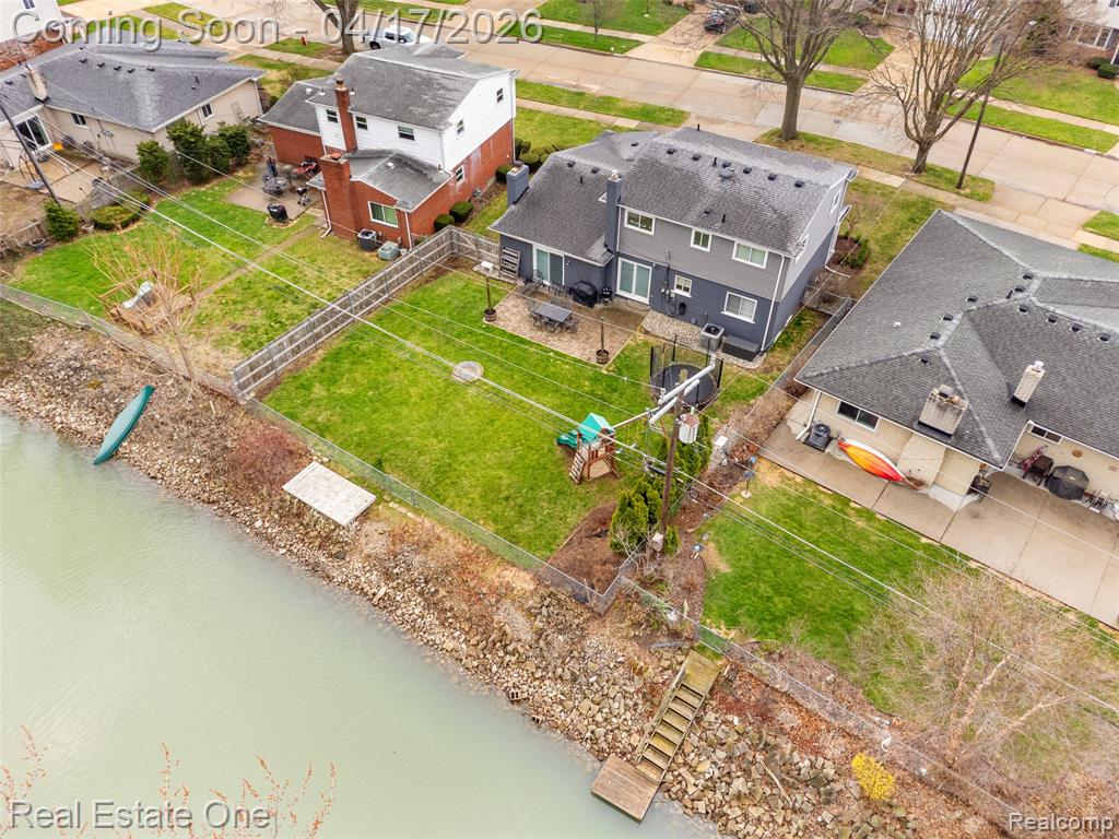 Aerial perspective of suburban area featuring a large body of water
