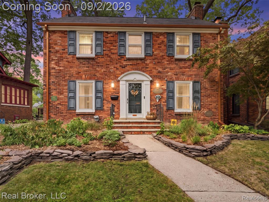 Brick exterior featuring multiple windows with shutters