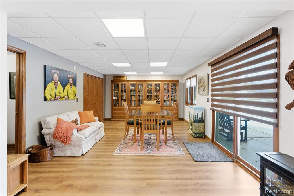 Dining area featuring a paneled ceiling and light wood-style floors
