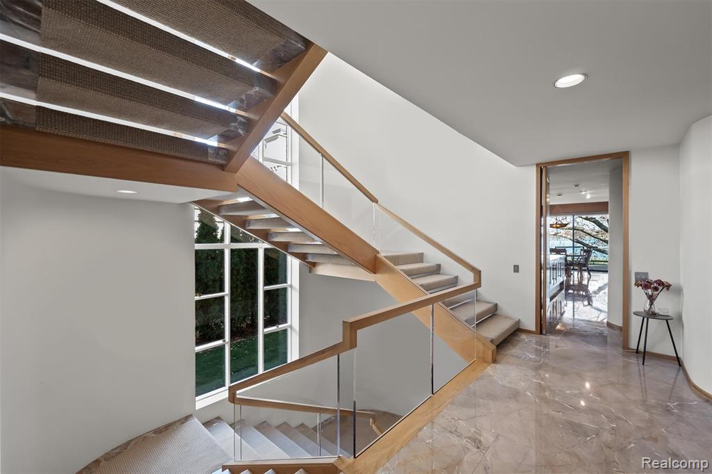 Stairs featuring recessed lighting and marble tiled flooring