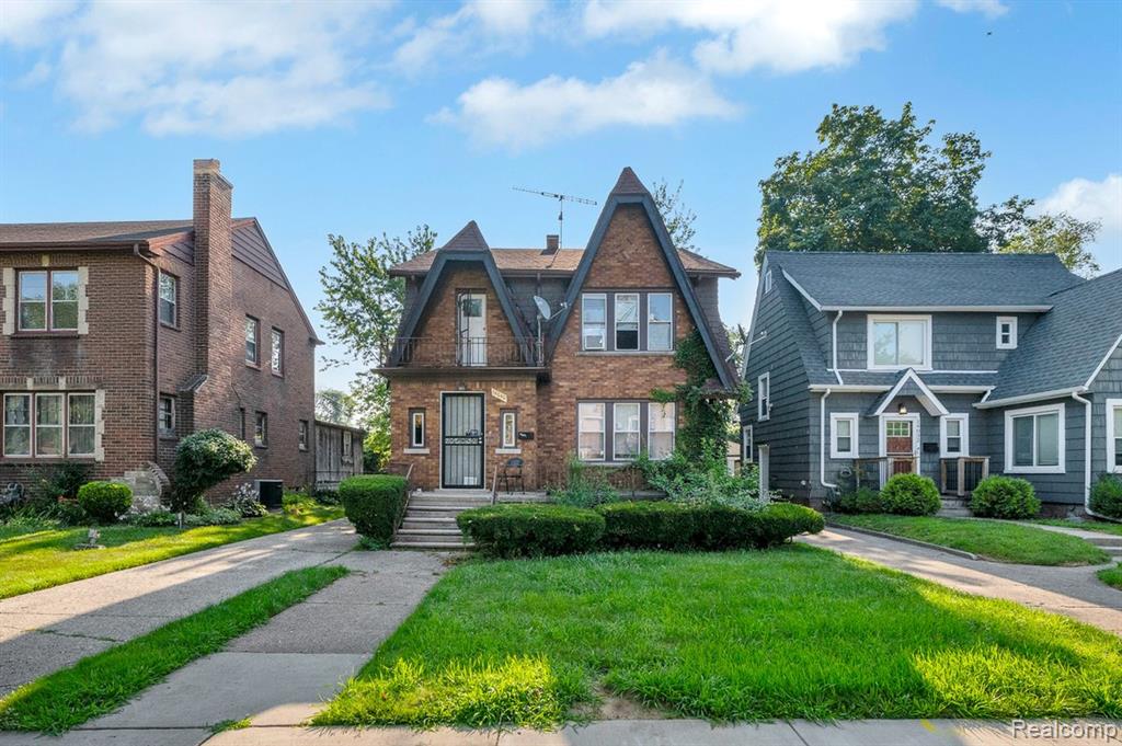 Photo for 14040 Asbury Park, Detroit, MI 48227 - listing #20251054239 Tudor house featuring a front yard and brick siding