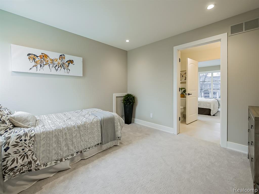 Bedroom featuring light colored carpet and recessed lighting