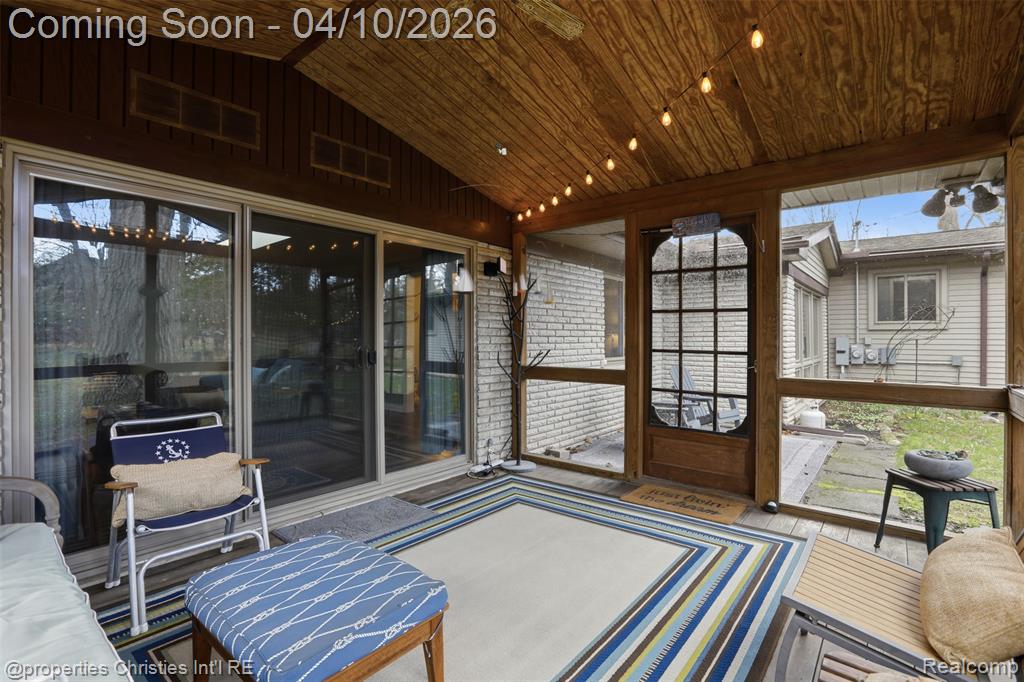 Sunroom features vaulted ceiling and a ceiling fan.