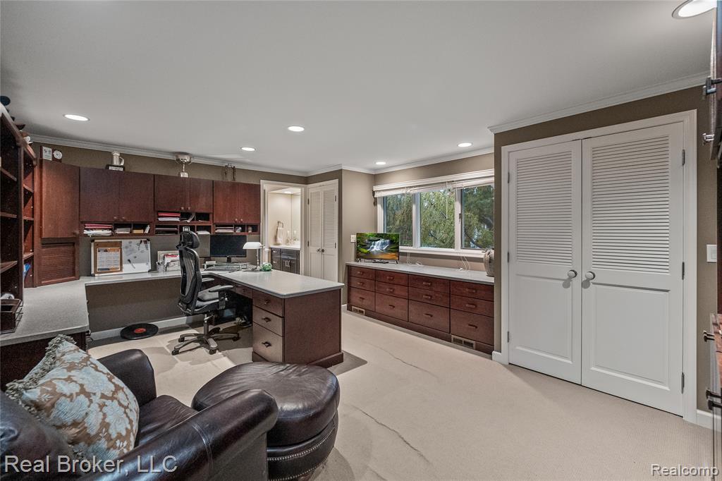 Home office featuring light carpet, recessed lighting, and ornamental molding