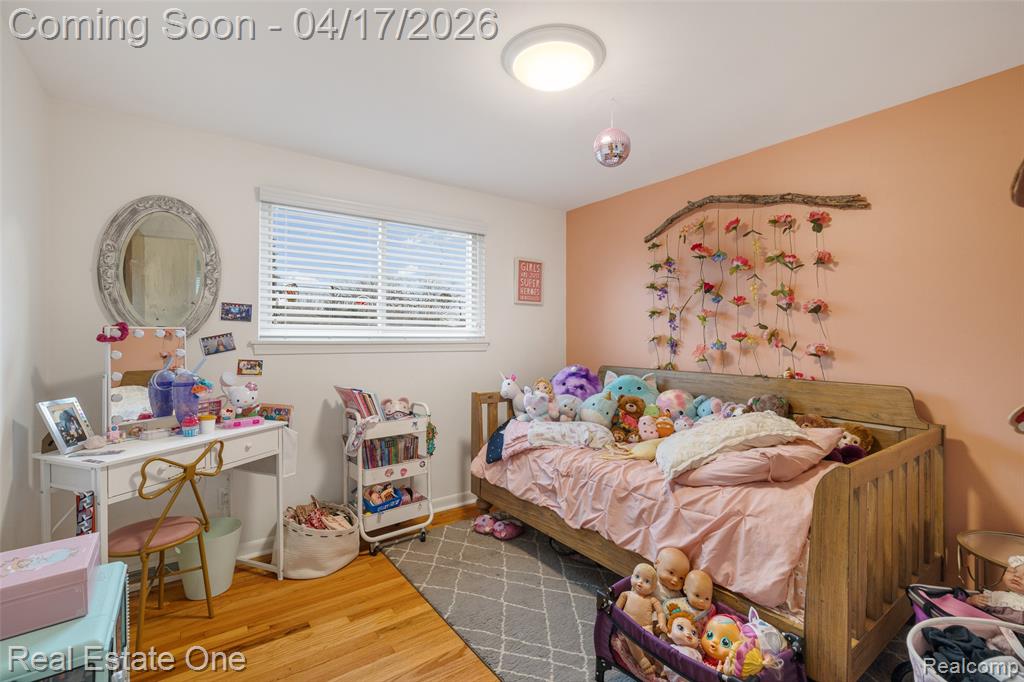 Bedroom with light wood-type flooring and baseboards