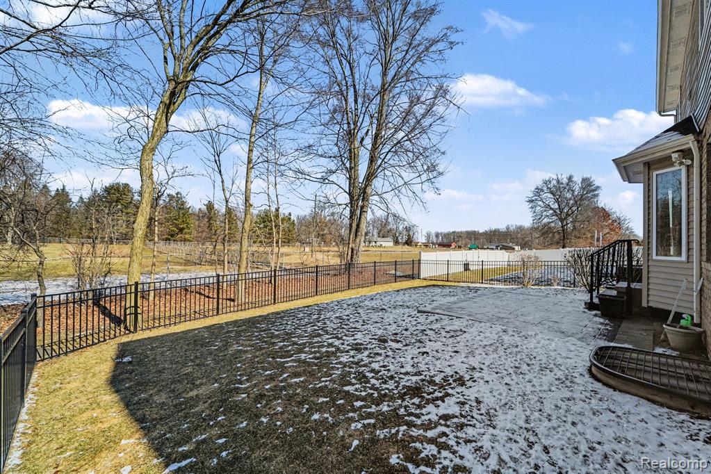 Fenced backyard with a patio area