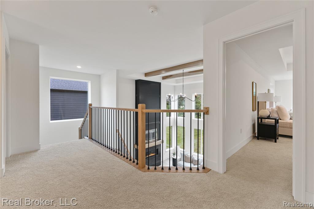Corridor with light carpet, beamed ceiling, an upstairs landing, a chandelier, and recessed lighting