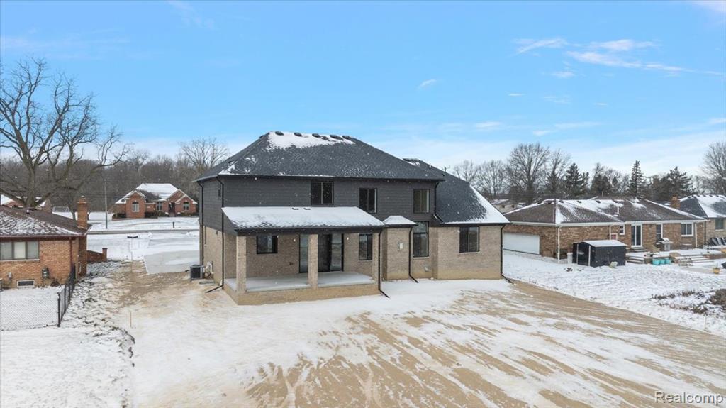 Rear of property with a patio and brick siding