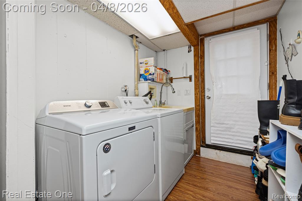 Laundry room featuring washing machine and dryer and dark wood finished floors