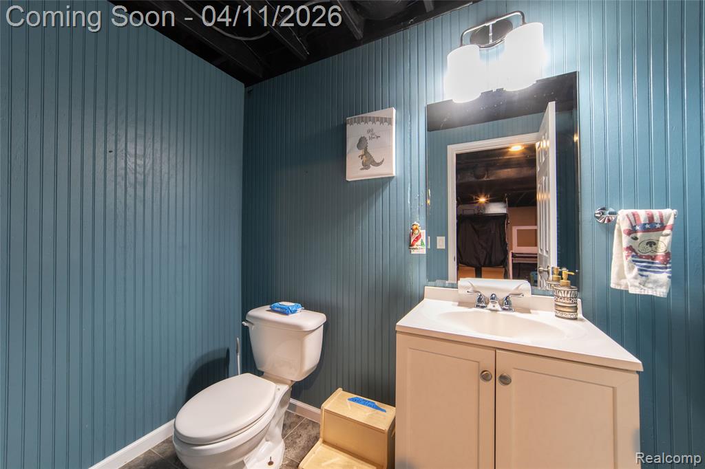 Half bathroom with toilet and vanity