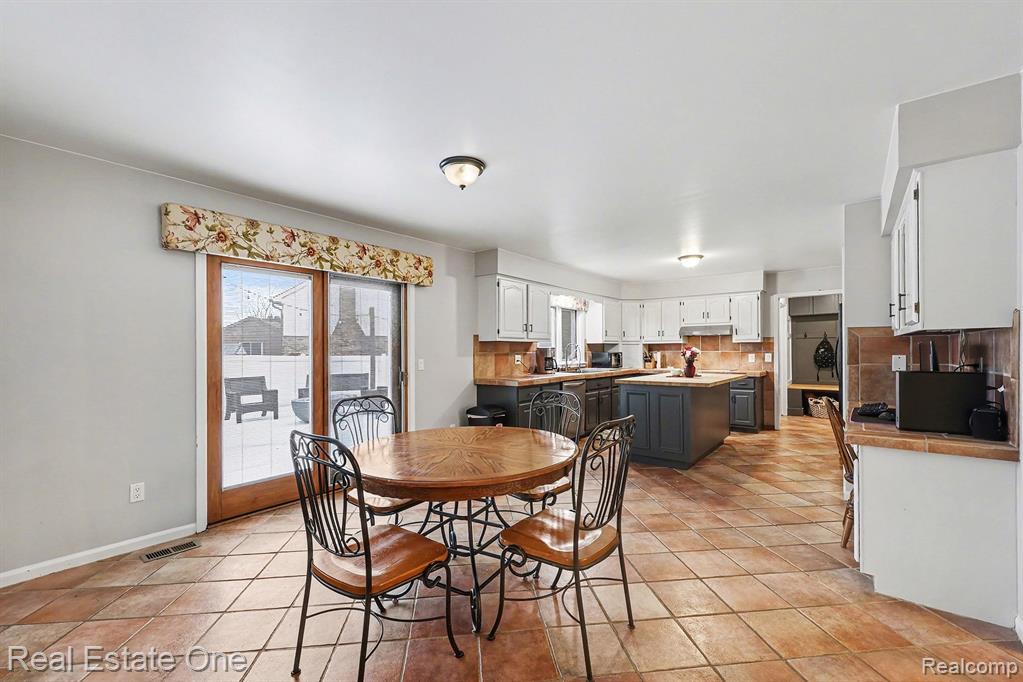 Dining space featuring baseboards and light tile patterned floors