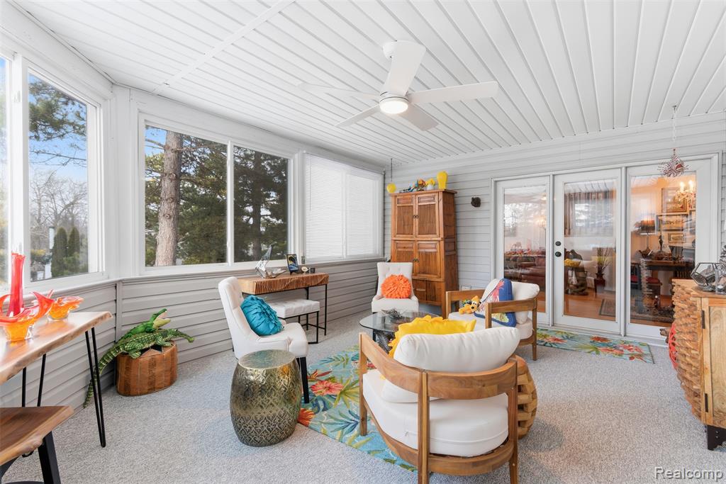 Sunroom featuring a ceiling fan