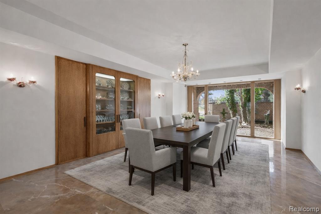 Dining area featuring a chandelier and a raised ceiling