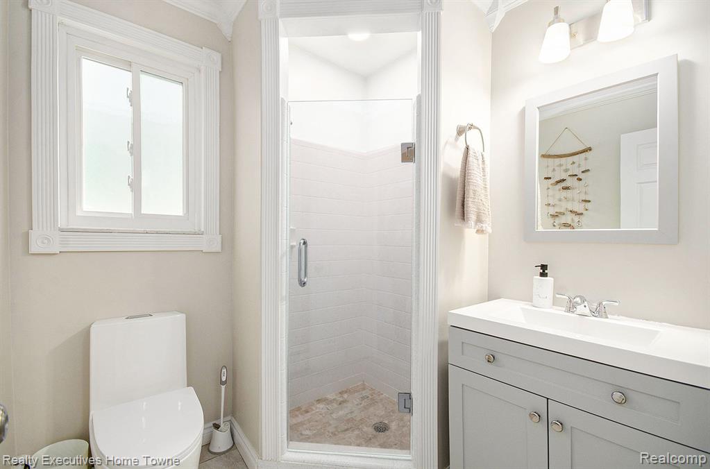 Full bath with vanity and a stall shower