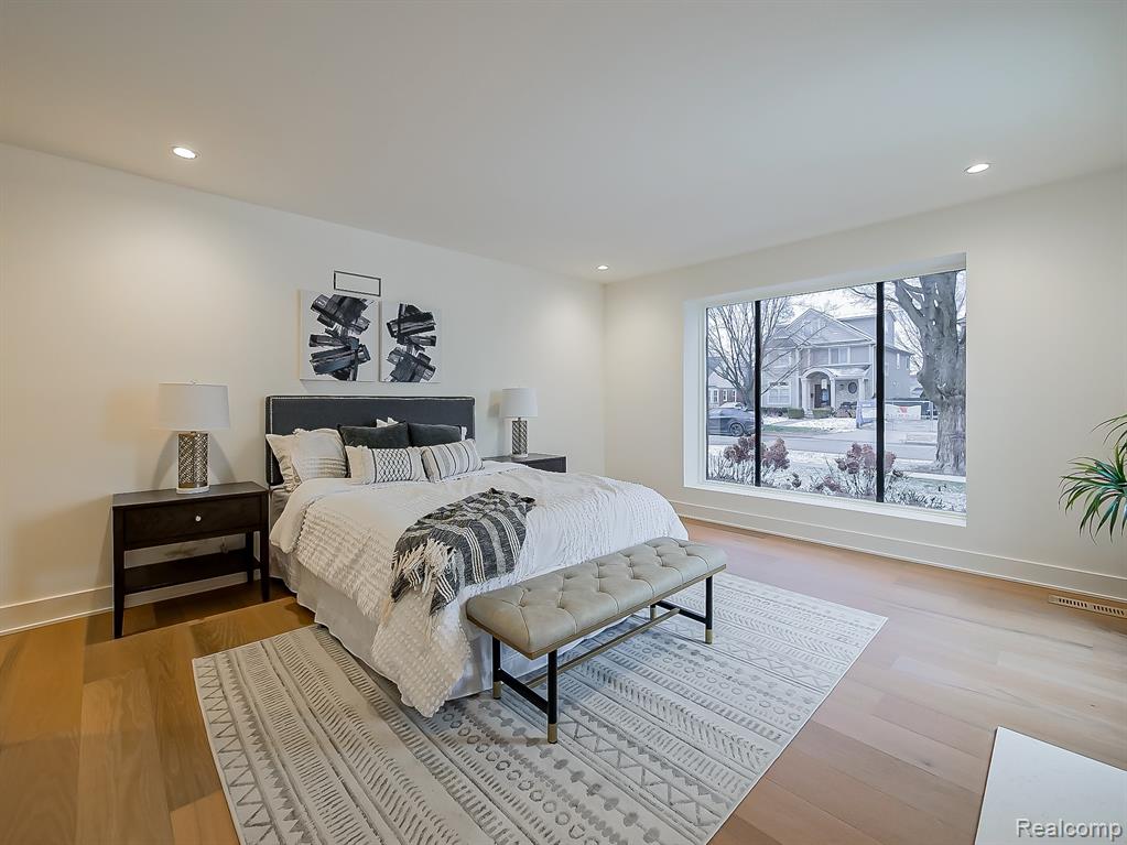Bedroom with light wood finished floors and recessed lighting