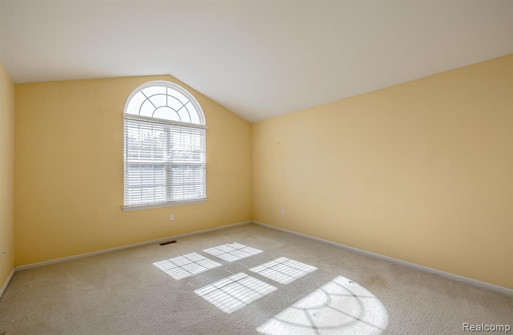 Sun filled arched window in Primary bedroom