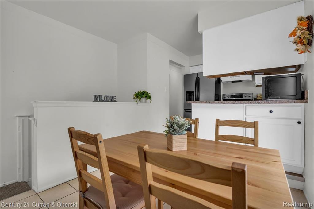 Dining area with light tile patterned floors
