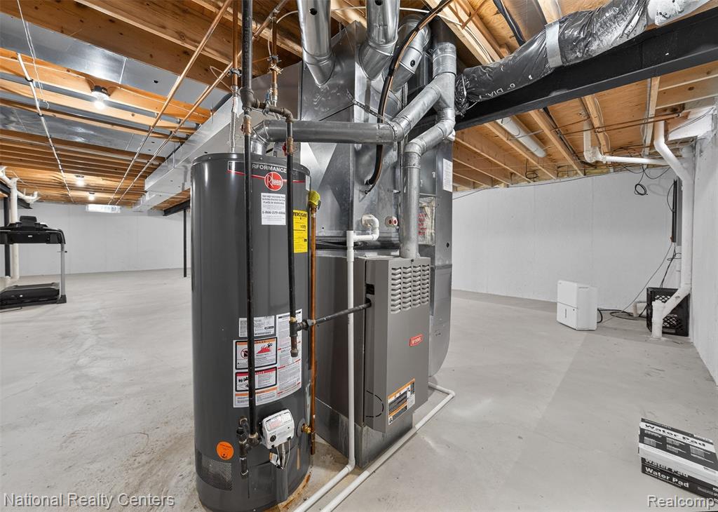 Unfinished below grade area with gas water heater and heating unit