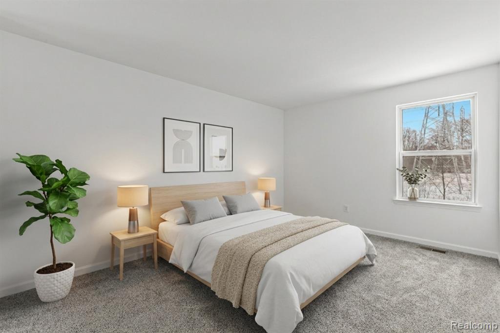Kitchen with appliances with stainless steel finishes, hanging light fixtures, light wood-style flooring, a center island, and recessed lighting